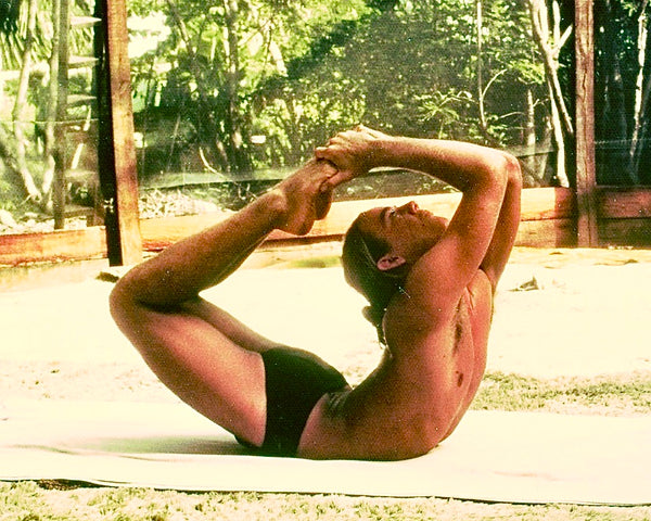 David Swenson author of Only Dead Fish Go With The Flow in  Padangustha Dhanurasana, 1975, Maui. Our yoga room had a carpeted, dirt floor
